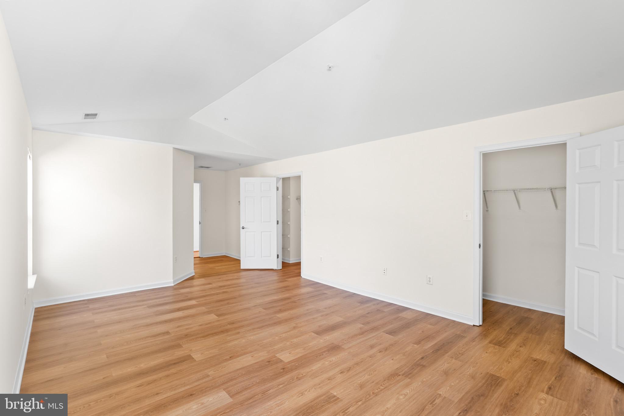 9602 Stuart Lane Clinton, MD 20735 - Photo 27 of 40 a view of an empty room with wooden floor