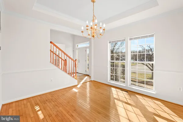 a view of a big room with wooden floor and stairs