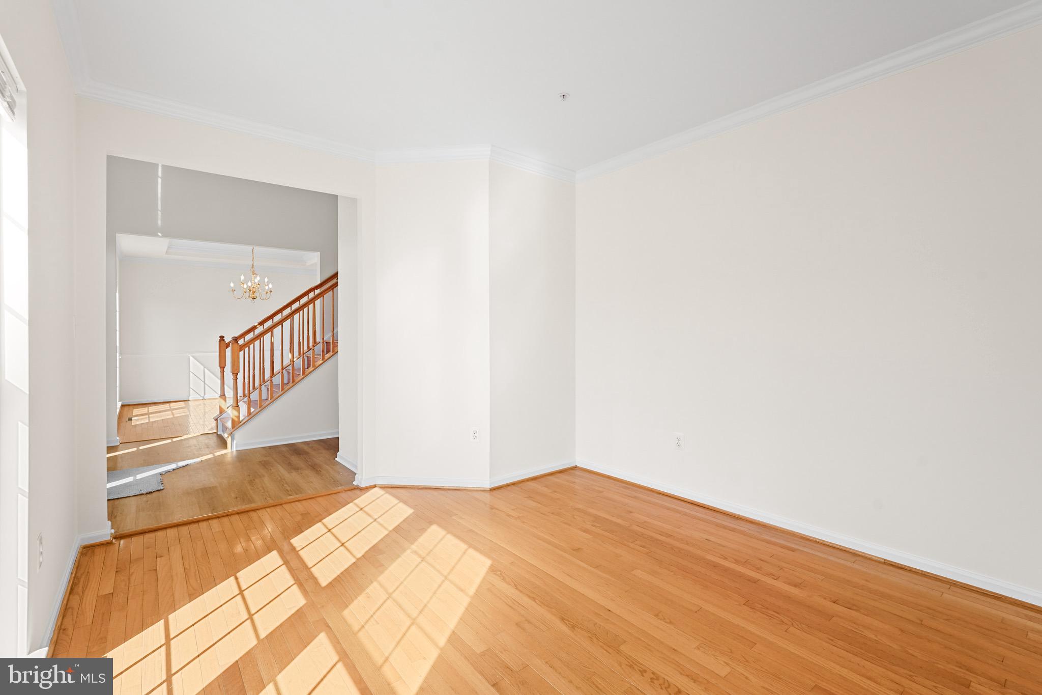 9602 Stuart Lane Clinton, MD 20735 - Photo 7 of 40 a view of a big room with wooden floor and stairs