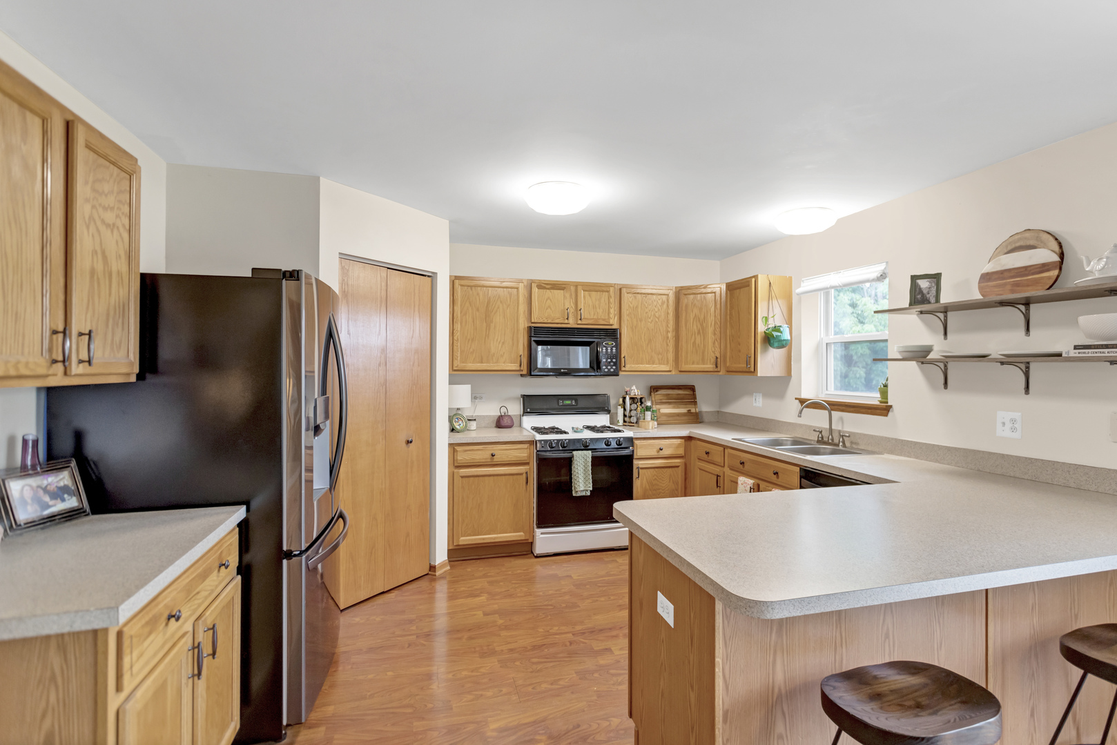 2112 Wicklow Lane Round Lake, IL 60073 - Photo 13 of 34 a kitchen with a refrigerator a sink a stove top oven and cabinets