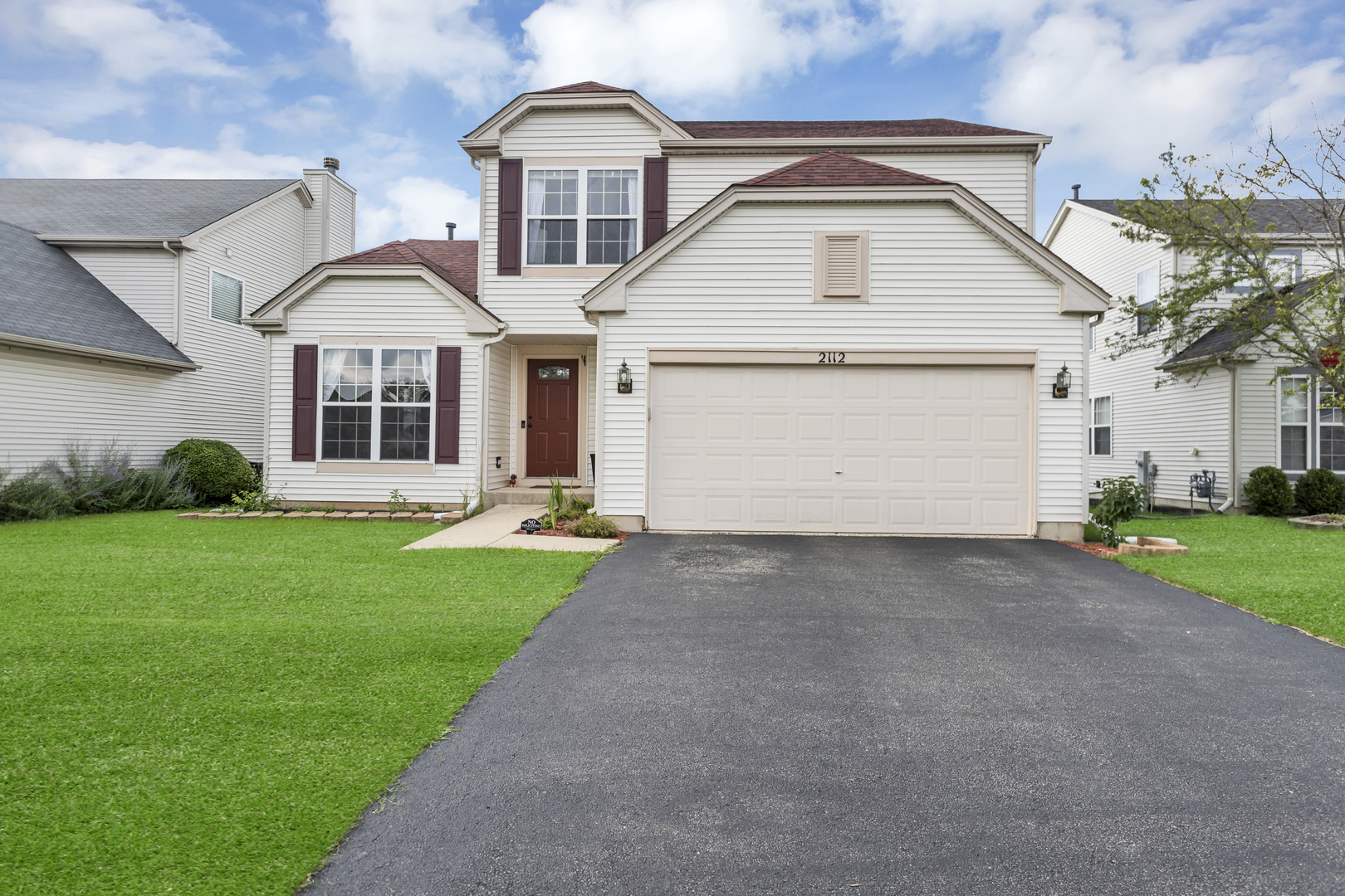 2112 Wicklow Lane Round Lake, IL 60073 - Photo 2 of 34 a front view of a house with a yard and garage