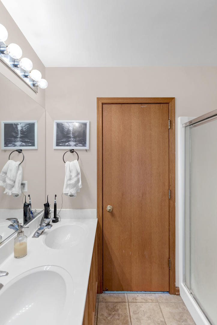2112 Wicklow Lane Round Lake, IL 60073 - Photo 26 of 34 a bathroom with a sink and a mirror