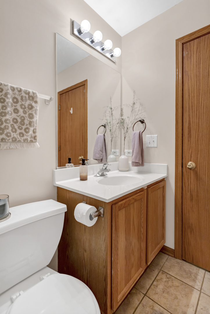 2112 Wicklow Lane Round Lake, IL 60073 - Photo 28 of 34 a bathroom with a granite countertop sink a toilet a mirror and shower