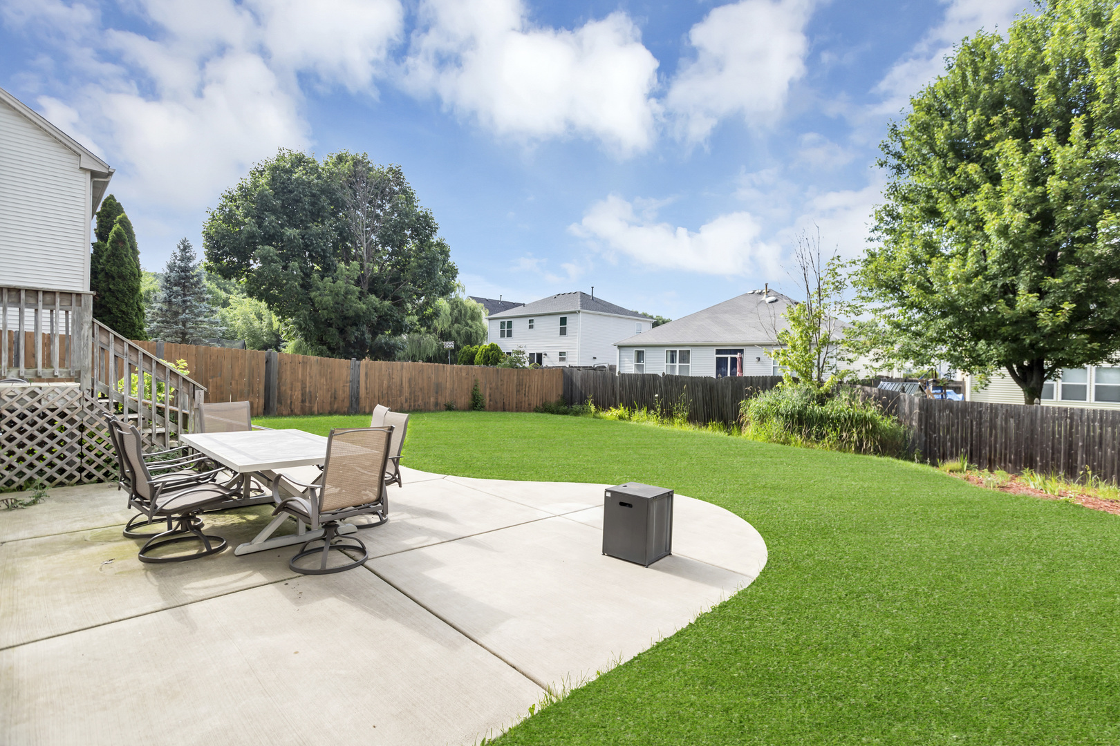 2112 Wicklow Lane Round Lake, IL 60073 - Photo 4 of 34 a view of a patio with a table chairs and a small yard