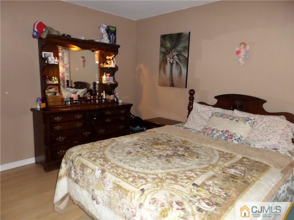 6 Baxter Road Edison, NJ 08817 - Photo 14 of 19 a bedroom with a bed and a mirror on dresser