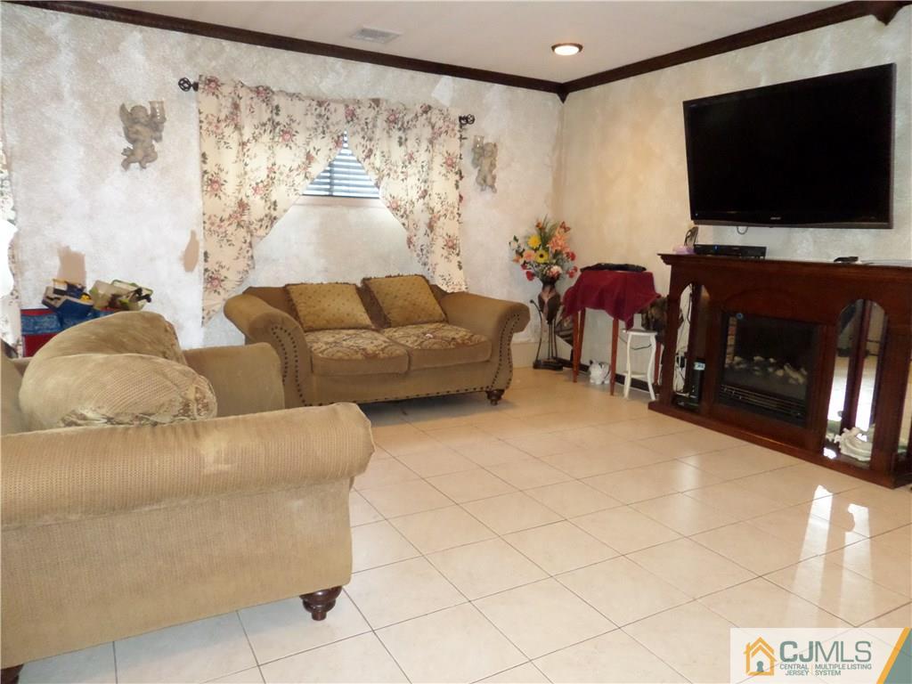 6 Baxter Road Edison, NJ 08817 - Photo 5 of 19 a living room with furniture and a flat screen tv