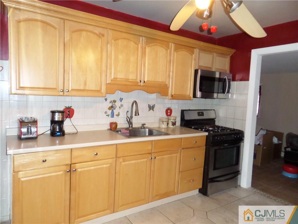 6 Baxter Road Edison, NJ 08817 - Photo 7 of 19 a kitchen with stainless steel appliances granite countertop a sink a stove cabinets and a refrigerator