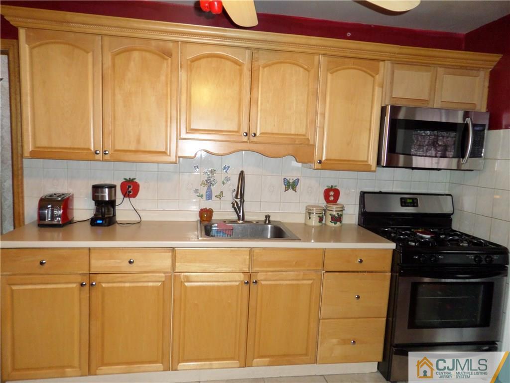 6 Baxter Road Edison, NJ 08817 - Photo 8 of 19 a kitchen with stainless steel appliances granite countertop a sink stove and cabinets