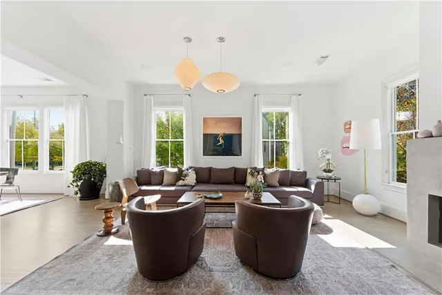 a living room with lots of furniture and a large window