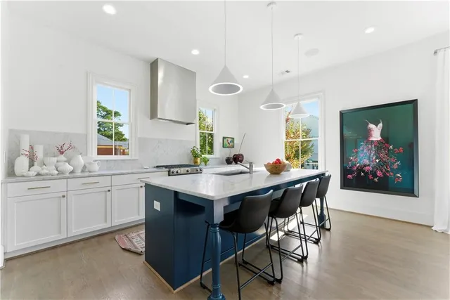 a large kitchen with kitchen island lots of counter space and a sink