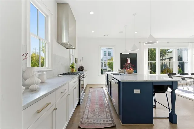 a kitchen with sink stove and view living room