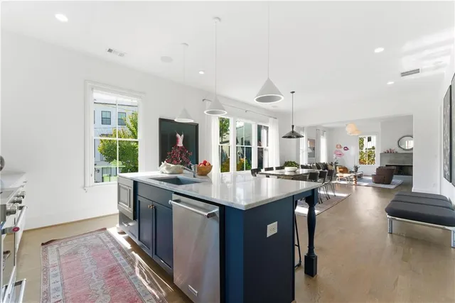 a large kitchen with kitchen island a sink stove and a refrigerator