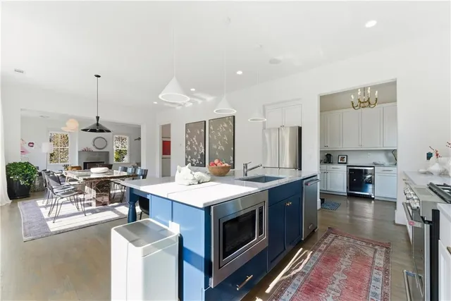 a kitchen with a white cabinets and window