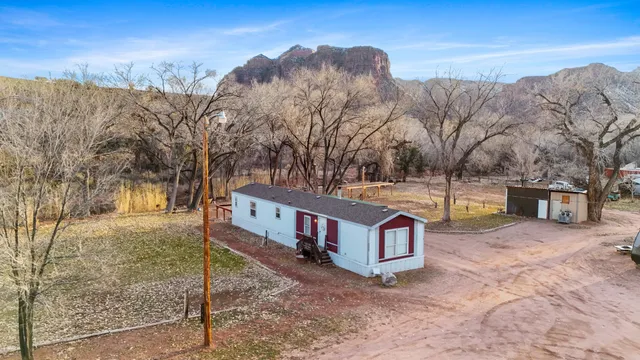 a view of a house with a yard covered with snow in the background