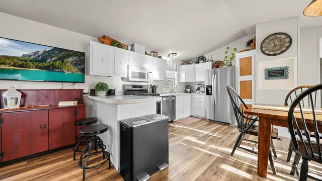 a kitchen with a table chairs and a stove top oven