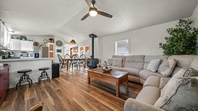 a living room with furniture and wooden floor