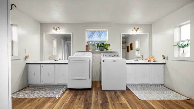 a view of kitchen with white cabinets and wooden floor
