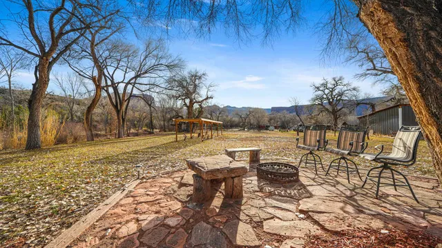 a view of a lake with a bench and trees