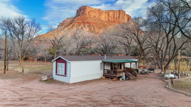 a view of a house with a yard and sitting area