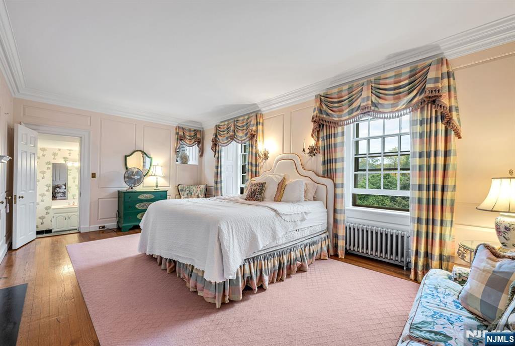 74 Village Road New Vernon, NJ 07976 - Photo 28 of 50 a bedroom with a bed a table and windows