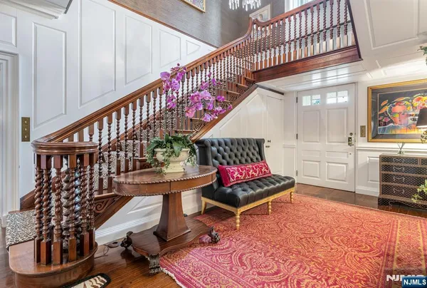a living room with furniture a rug and a chandelier