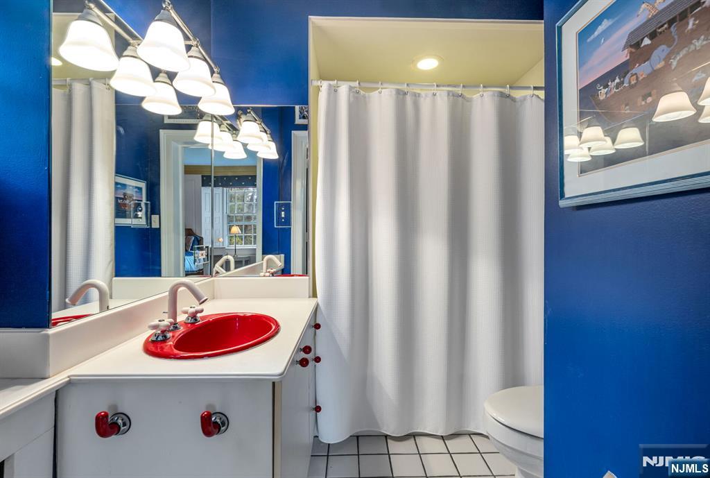 74 Village Road New Vernon, NJ 07976 - Photo 32 of 50 a bathroom with a sink and a mirror