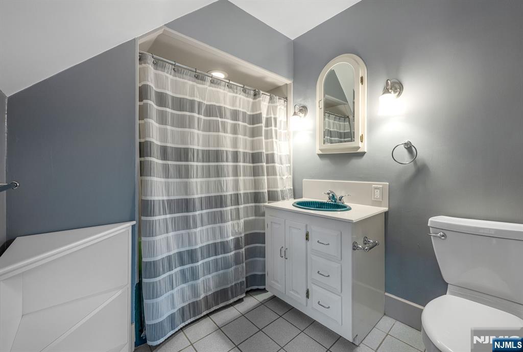 74 Village Road New Vernon, NJ 07976 - Photo 35 of 50 a bathroom with a granite countertop toilet sink and mirror