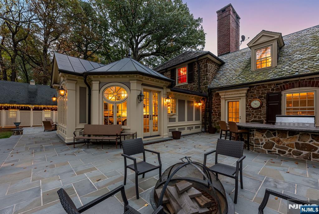 74 Village Road New Vernon, NJ 07976 - Photo 48 of 50 a backyard of a house with barbeque oven table and chairs