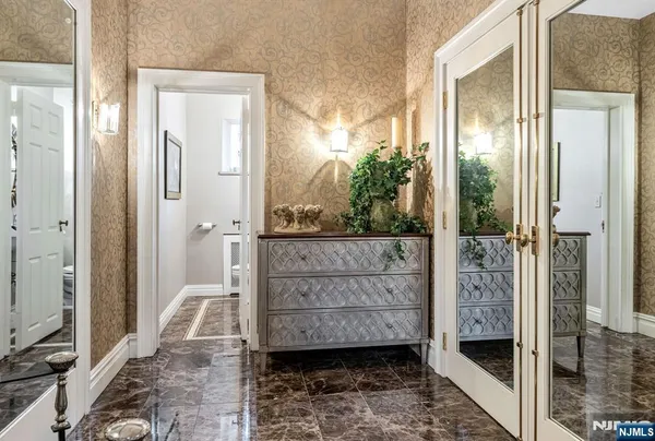 a bathroom with a glass door shower and a sink