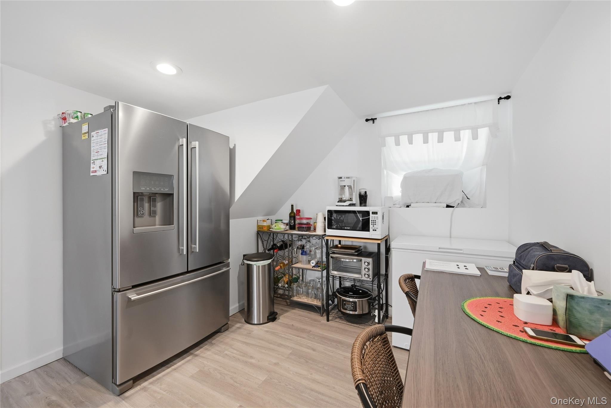 35 Randall Road Shoreham, NY 11786 - Photo 22 of 32 a kitchen with stainless steel appliances a refrigerator and a wooden floor