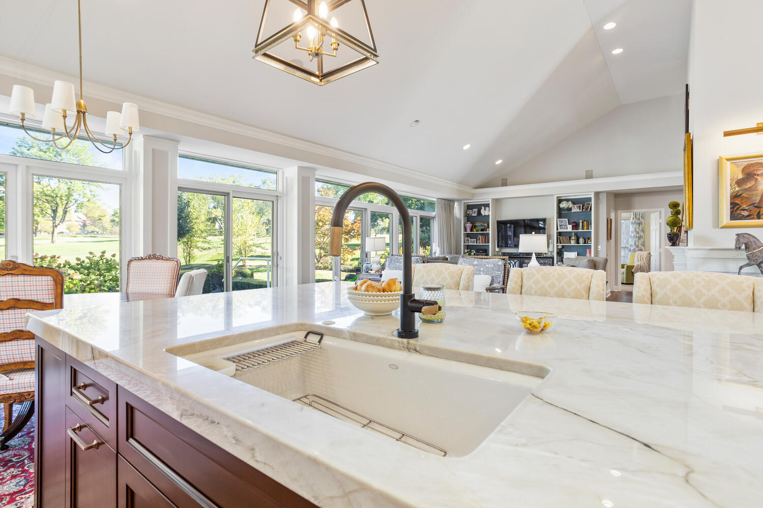 7 Greencroft Drive Champaign, IL 61821 - Photo 18 of 45 a view of a kitchen with kitchen island a large window cabinets a sink and stainless steel appliances