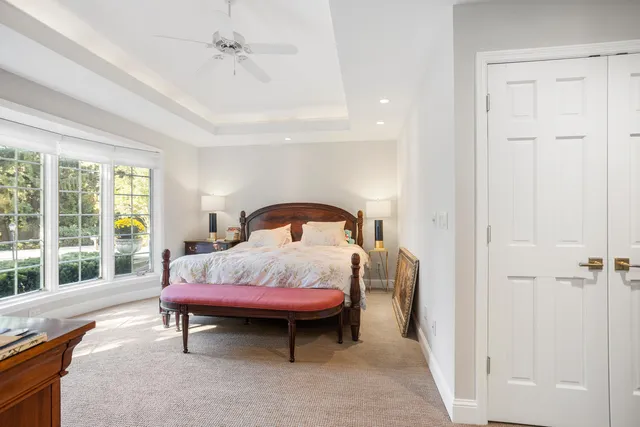 a bedroom with a bed and a large window