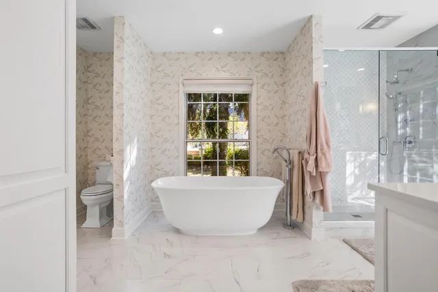 a en suite bathroom with a granite countertop sink mirror and shower