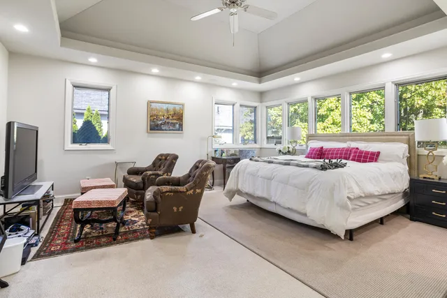 a bedroom with a bed and a large window