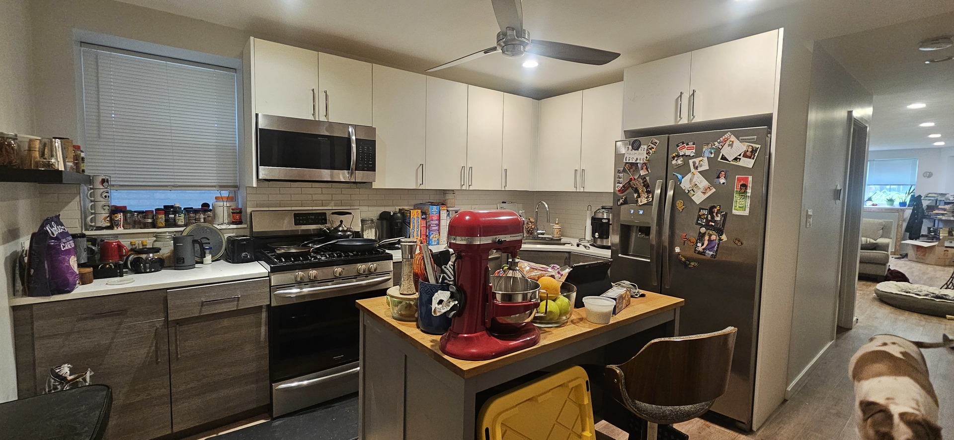 2952 West Nelson Street, Unit G Chicago, IL 60618 - Photo 7 of 12 a kitchen with stainless steel appliances kitchen island granite countertop a stove refrigerator and cabinets