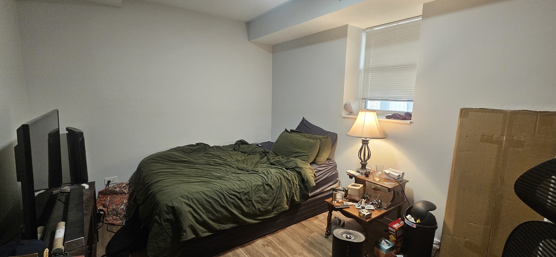 2952 West Nelson Street, Unit G Chicago, IL 60618 - Photo 10 of 12 a bedroom with a bed and a flat tv screen on the dresser