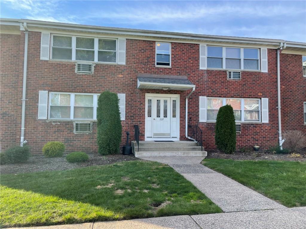 237 North Middletown Road, Unit F Pearl River, NY 10965 - Photo 1 of 1 front view of a brick house with a yard