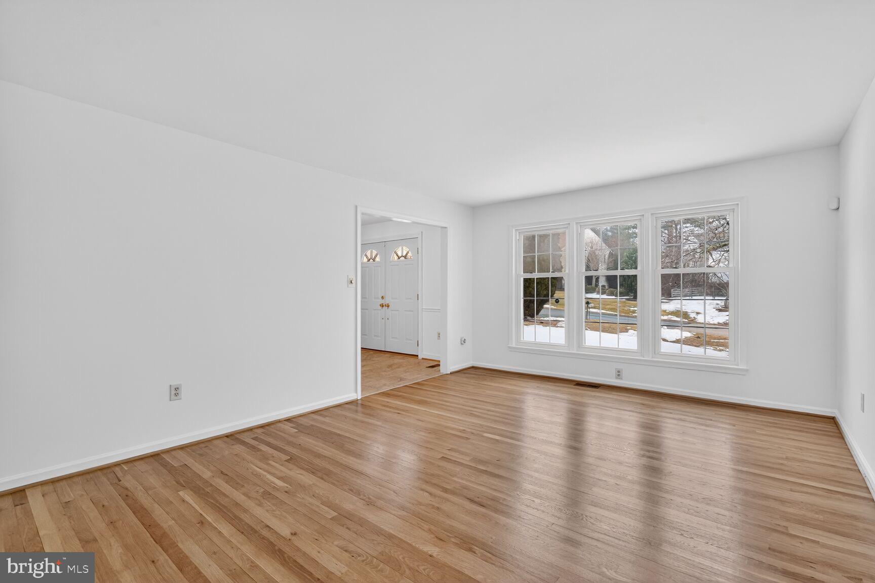 15200 Winstead Lane Silver Spring, MD 20905 - Photo 13 of 53 a view of an empty room with wooden floor and a window