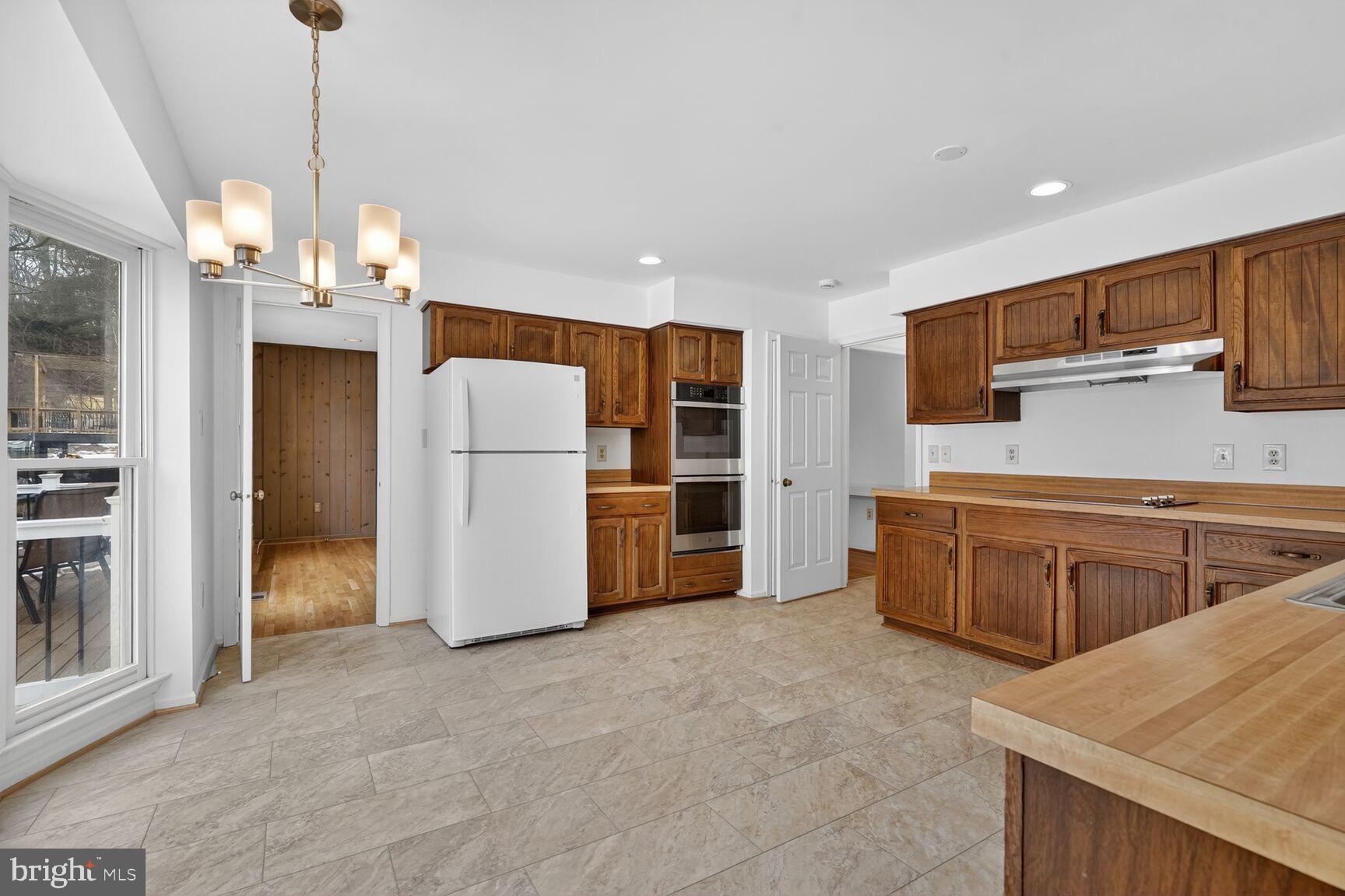 15200 Winstead Lane Silver Spring, MD 20905 - Photo 19 of 53 a kitchen with refrigerator and cabinets