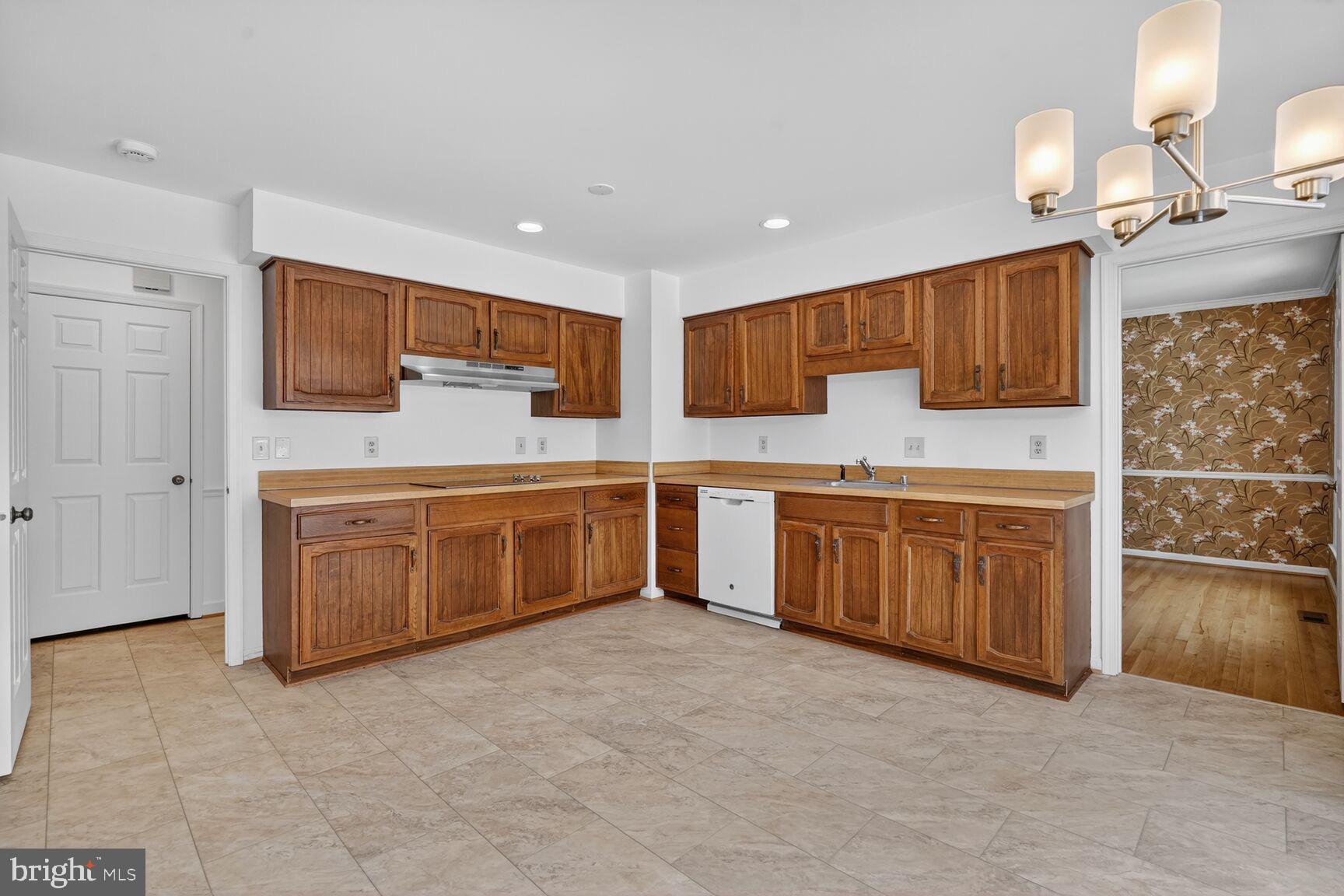 15200 Winstead Lane Silver Spring, MD 20905 - Photo 21 of 53 a kitchen with a stove top oven sink and cabinets