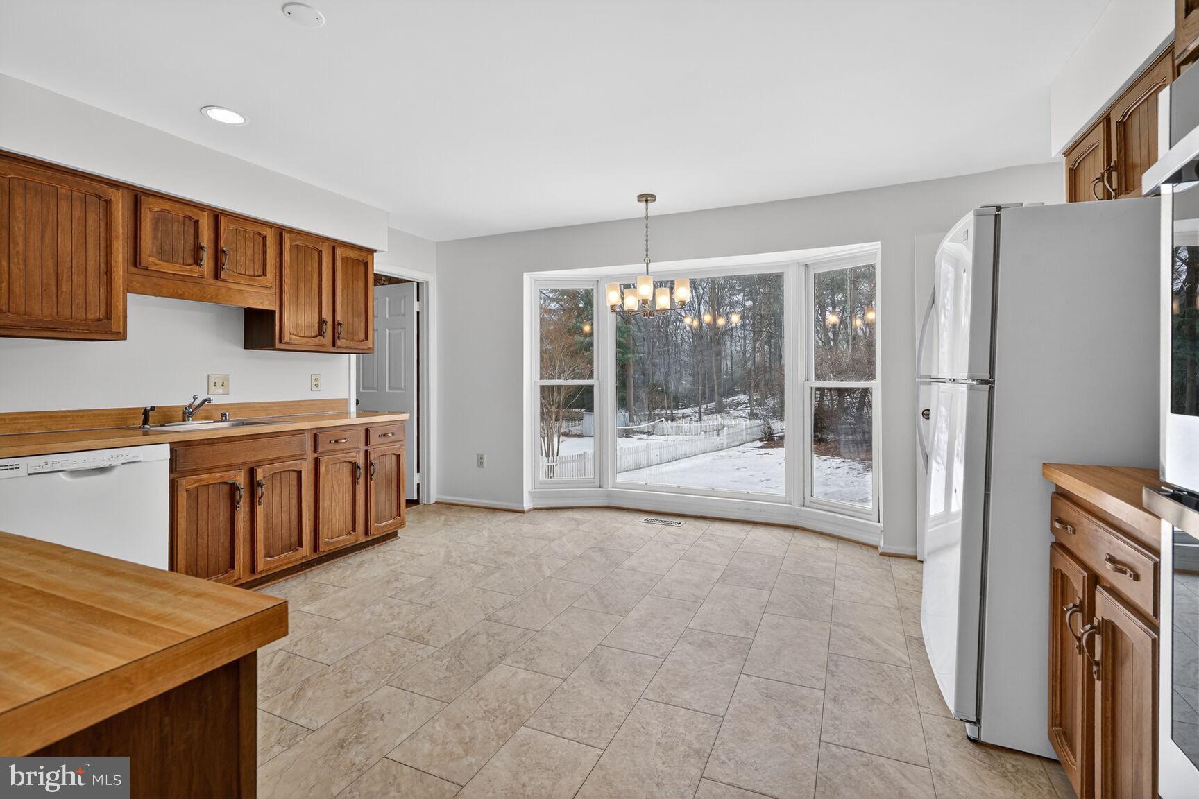 15200 Winstead Lane Silver Spring, MD 20905 - Photo 22 of 53 a open kitchen with stainless steel appliances granite countertop a refrigerator and a stove top oven