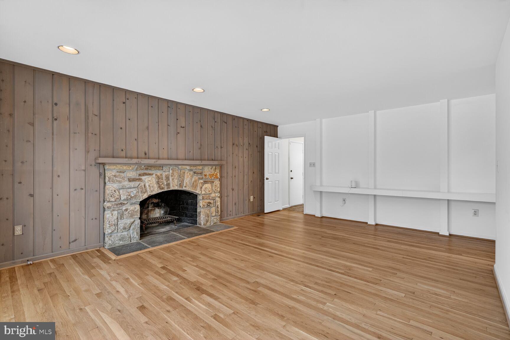 15200 Winstead Lane Silver Spring, MD 20905 - Photo 24 of 53 a view of empty room with wooden floor and fireplace