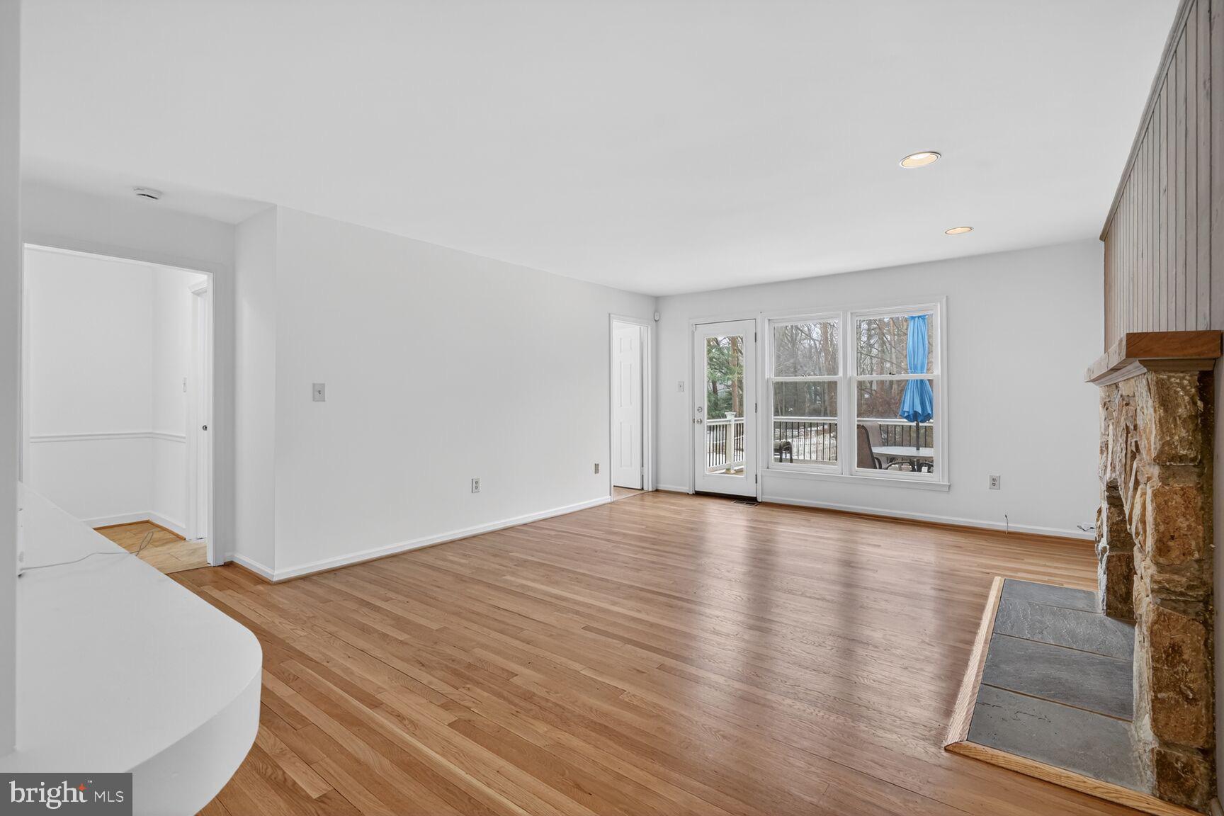 15200 Winstead Lane Silver Spring, MD 20905 - Photo 25 of 53 a view of a livingroom with wooden floor and a fireplace