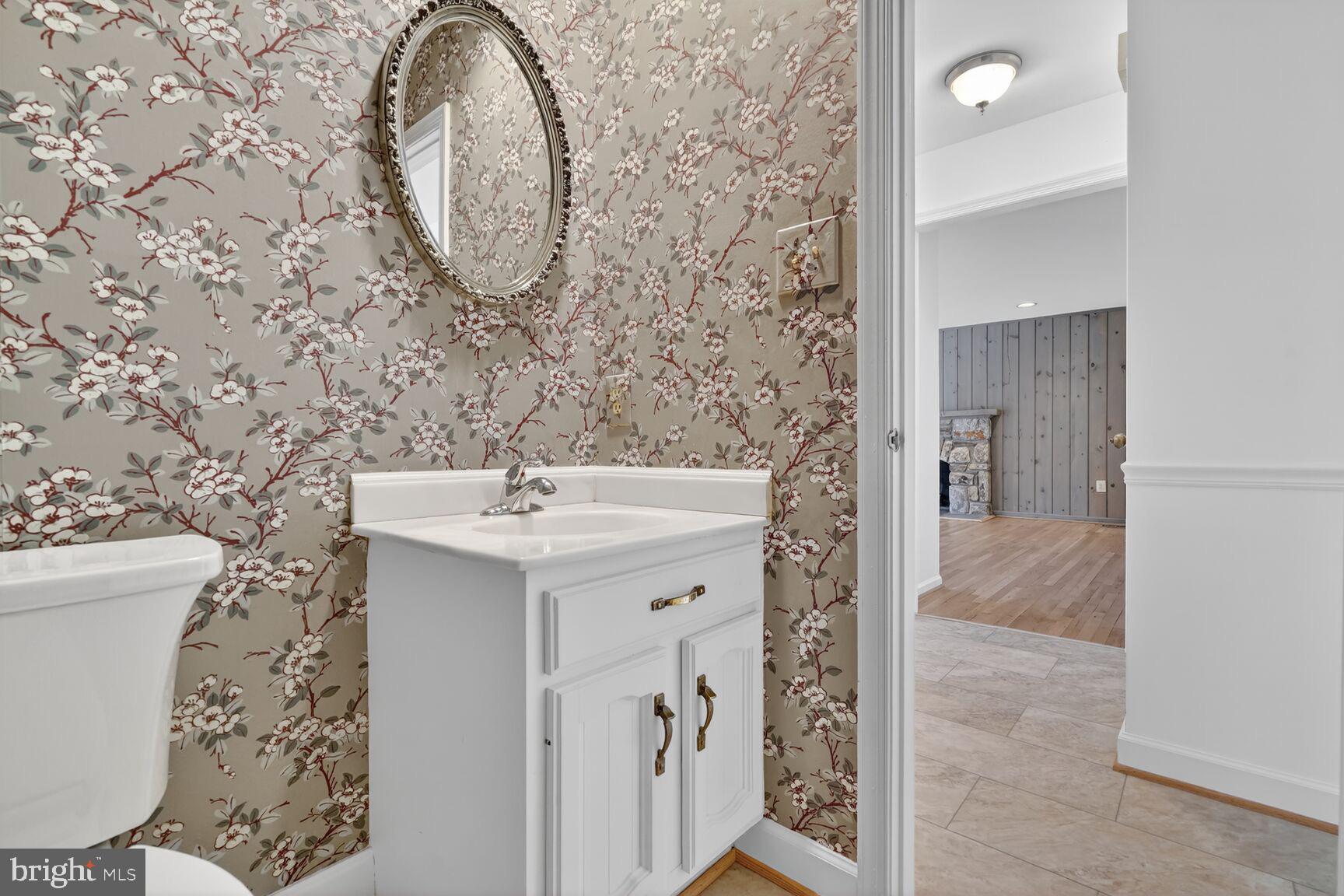 15200 Winstead Lane Silver Spring, MD 20905 - Photo 29 of 53 a bathroom with a sink and a mirror