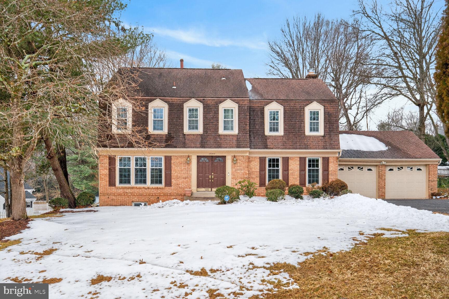 15200 Winstead Lane Silver Spring, MD 20905 - Photo 3 of 53 a front view of a house with a yard covered with snow