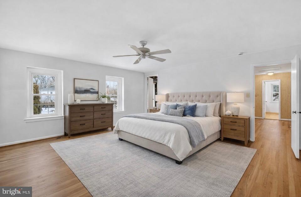 15200 Winstead Lane Silver Spring, MD 20905 - Photo 33 of 53 a spacious bedroom with a bed a dresser and a chandelier