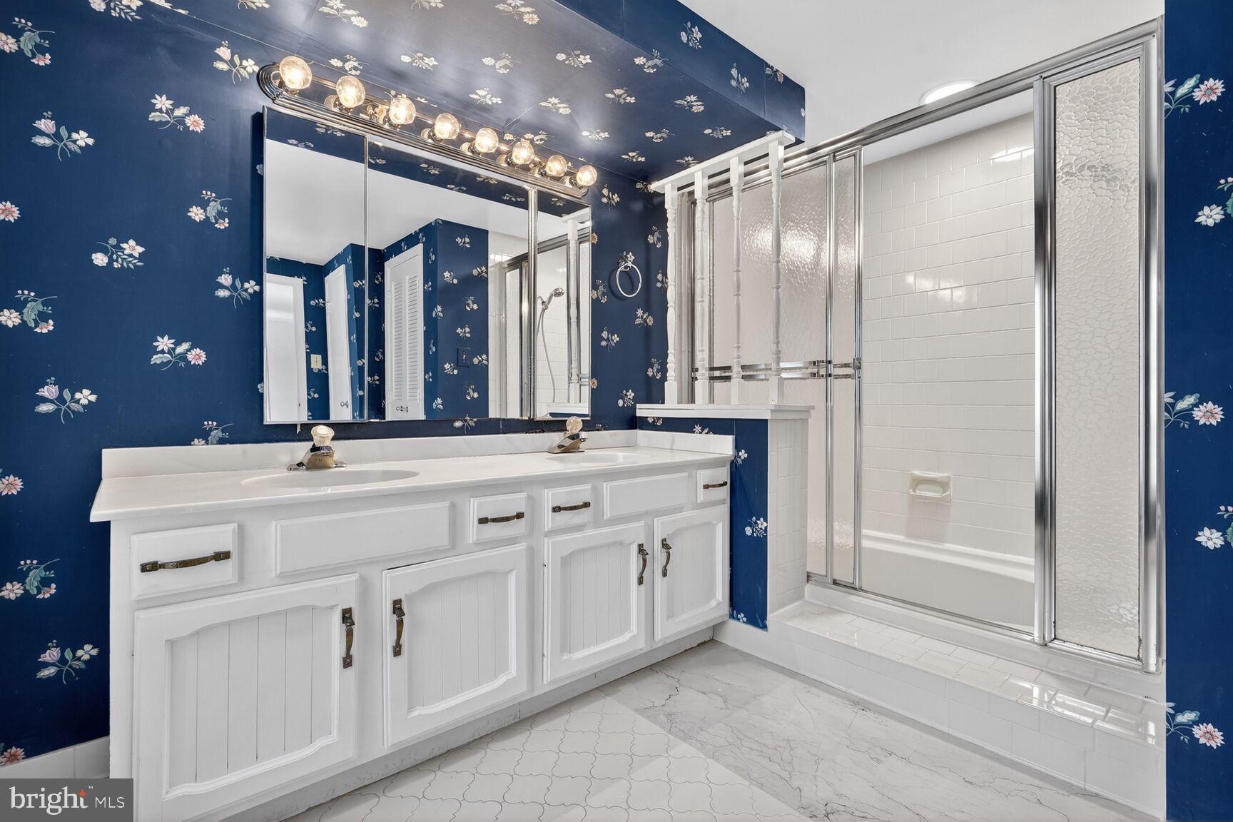 15200 Winstead Lane Silver Spring, MD 20905 - Photo 34 of 53 a bathroom with a double vanity sink a mirror and a shower