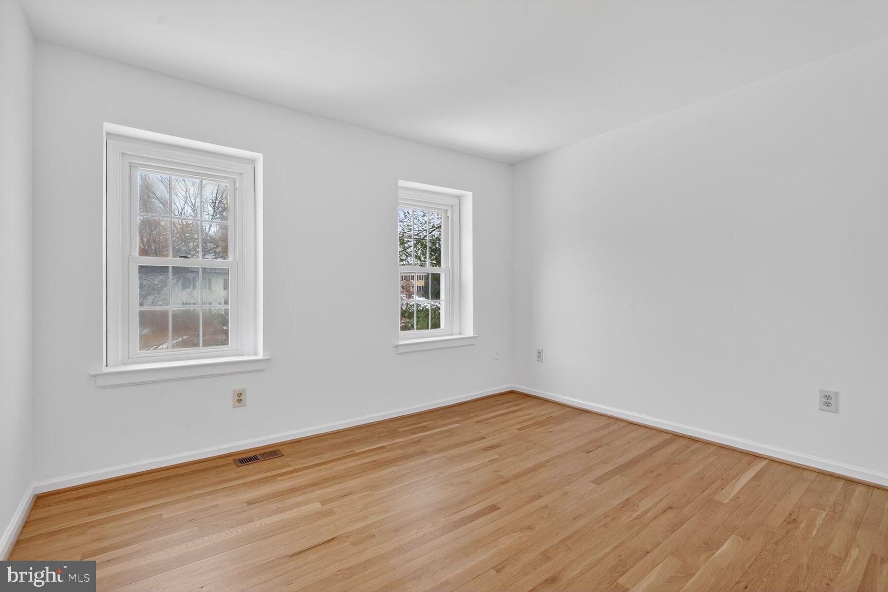 15200 Winstead Lane Silver Spring, MD 20905 - Photo 39 of 53 an empty room with wooden floor and windows