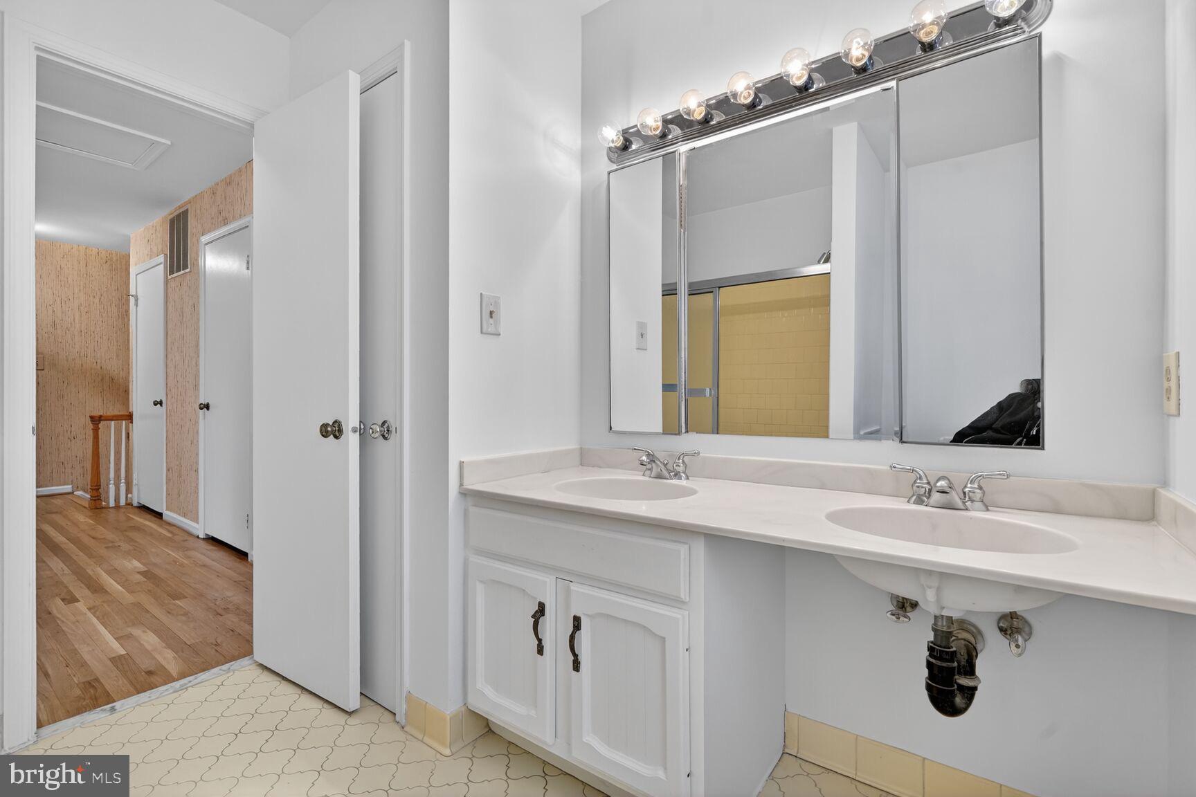15200 Winstead Lane Silver Spring, MD 20905 - Photo 43 of 53 a bathroom with a sink double vanity and a mirror