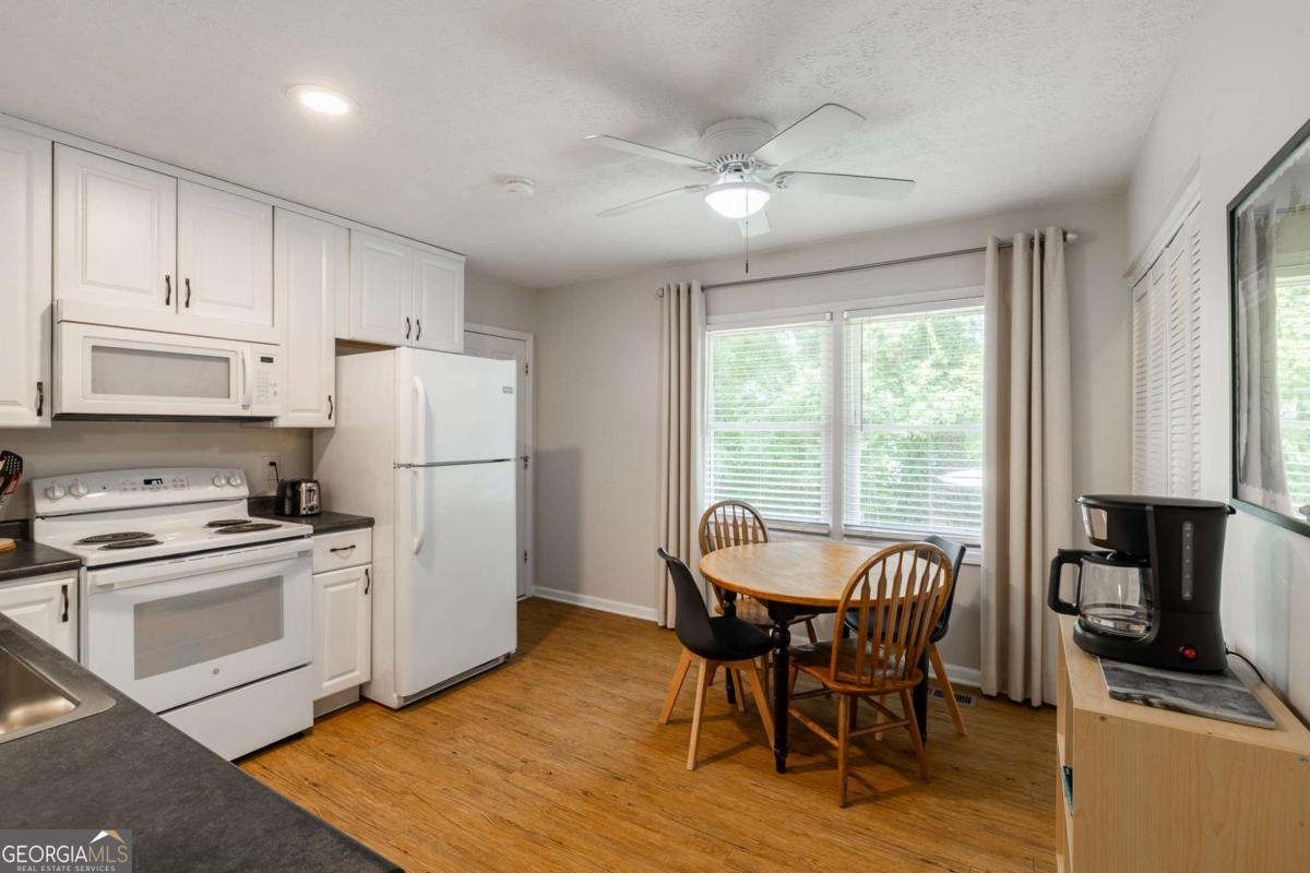 168 Pearl Street Athens, GA 30601 - Photo 10 of 43 a kitchen with stainless steel appliances granite countertop a stove a refrigerator a kitchen island a dining table and chairs